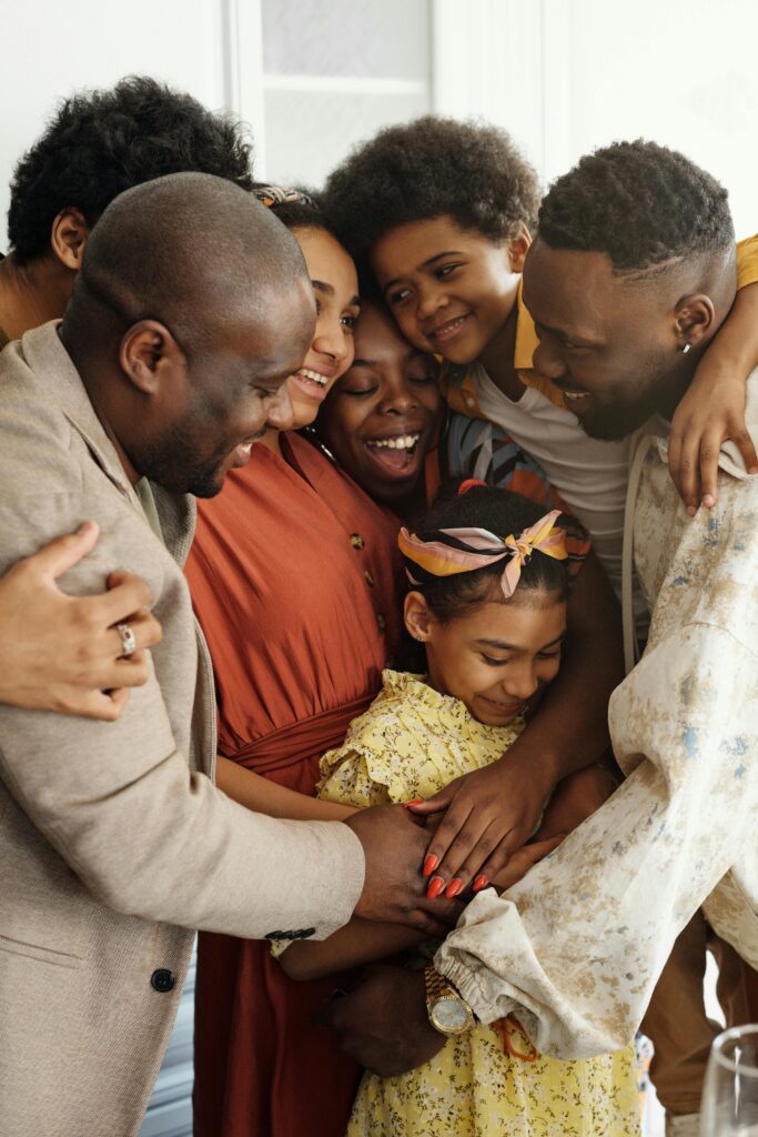 Heartwarming family group hug showcasing affection and togetherness indoors because they have created a legacy plan.